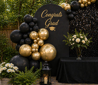Translation missing: en.Tier 2 Gold and black graduation party in a box balloon setup with backdrop